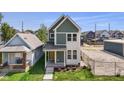Charming two-story home with a welcoming front porch and fresh landscaping at 1405 Deloss St, Indianapolis, IN 46201
