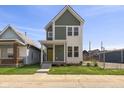 Inviting two-story home with a bright yellow front door and manicured lawn at 1405 Deloss St, Indianapolis, IN 46201