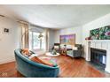 Spacious living room with large window, fireplace, hardwood flooring, and stylish decor at 1548 N Park Ave, Indianapolis, IN 46202