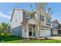 Charming two-story home with blue siding, a white brick foundation, and a well-manicured lawn at 1669 Windrush Pl, Westfield, IN 46074