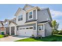 Stylish home with gray siding, a white garage door, and a meticulously maintained lawn at 1669 Windrush Pl, Westfield, IN 46074