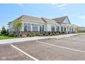 A one-story community building showcasing accessible parking, covered entrance, and attractive landscaping at 1694 Windrush Pl, Westfield, IN 46074