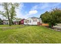 A quaint bungalow with solar panels situated on a grass corner lot at 2164 E Raymond St, Indianapolis, IN 46203
