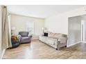 Bright living room featuring hardwood floors, neutral walls, and comfortable seating at 2405 E 9Th St, Anderson, IN 46012