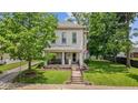Inviting two-story home with a cozy front porch and well-manicured lawn at 245 S Washington St, Danville, IN 46122