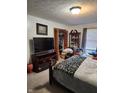 Cozy bedroom with a comfortable bed, wardrobe, and a well lit window at 247 Meridian Ct, Pittsboro, IN 46167