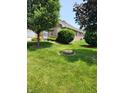 Well-manicured lawn surrounding a brick home, offering a serene outdoor setting at 247 Meridian Ct, Pittsboro, IN 46167