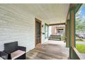 Inviting front porch with a classic porch swing, chair, and charming details at 31 S Hinman St, Columbus, IN 47201