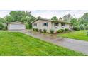 Exterior view of home and detached garage with a concrete driveway at 3201 Chamberlin Dr, Indianapolis, IN 46227