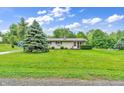 A well-kept lawn surrounds the charming home, showcasing its curb appeal at 3201 Chamberlin Dr, Indianapolis, IN 46227