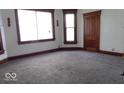Bedroom with carpet flooring, natural light, and wood trim at 340 W 11Th St, Anderson, IN 46016