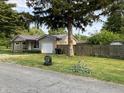 Charming single-story home with vinyl siding, metal roof and attached one car garage at 501 W Taylor St, Alexandria, IN 46001