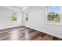 Sunny bedroom featuring stylish wood-look flooring and large windows, creating a bright and inviting space at 541 Dayton Ave, Indianapolis, IN 46203
