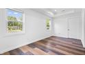 Bright bedroom with hardwood floors and large windows providing ample natural light with views of the neighborhood at 541 Dayton Ave, Indianapolis, IN 46203