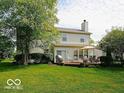 Spacious backyard featuring a wooden deck with an outdoor seating area, perfect for relaxation at 5883 Sandalwood Dr, Carmel, IN 46033