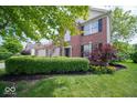 Attractive two-story brick home with manicured front lawn and mature landscaping at 5883 Sandalwood Dr, Carmel, IN 46033
