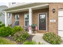 Inviting front porch with rocking chairs and decorative plants for curb appeal at 6296 Sugar Maple Dr, Zionsville, IN 46077