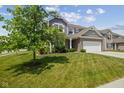 Well-maintained front lawn and exterior view of a two-story home with an attached garage at 632 Albermarle Dr, Pittsboro, IN 46167