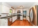 Well-equipped kitchen with stainless steel appliances, white cabinets, and wood flooring, ready for culinary adventures at 6580 Kings Ct, Avon, IN 46123