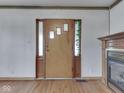 Entryway featuring a wooden door with sidelights and a fireplace at 70 Fairground St, Franklin, IN 46131