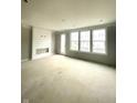 Living room with a decorative fireplace and large windows at 7317 Bayview Run, McCordsville, IN 46055