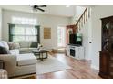 Bright living room featuring wood floors, a neutral color palette, and comfortable seating at 7402 Northfield Blvd, Fishers, IN 46038