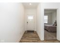 Bright hallway leading to a bedroom, featuring a wood-look floor and white trim at 794 Harley Ln, Westfield, IN 46074