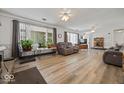 Open living room featuring hardwood floors, natural light, and neutral paint at 8244 E Hadley Rd, Camby, IN 46113