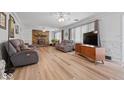 Bright living room with hardwood floors, a stone fireplace and neutral paint at 8244 E Hadley Rd, Camby, IN 46113
