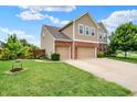 Well-maintained lawn and landscaping complement this lovely two-story home with a three-car garage at 916 Settlers Walk, Brownsburg, IN 46112
