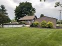 Backyard with an above-ground pool and well-manicured lawn and landscaping at 9467 N Michigan Rd, Fairland, IN 46126