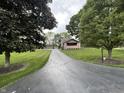 View of the home from the long driveway and showing the detached garage at 9467 N Michigan Rd, Fairland, IN 46126