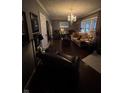 Cozy living room with hardwood floors, chandelier and comfortable seating at 9467 N Michigan Rd, Fairland, IN 46126