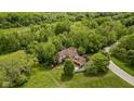 Aerial view of home, showcasing mature trees and beautiful landscaping at 9601 Irishmans Run Ln, Zionsville, IN 46077