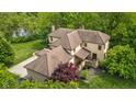 Aerial view of the home with tile roof showcasing the lush landscaping at 9601 Irishmans Run Ln, Zionsville, IN 46077