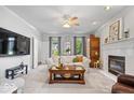 Comfortable living room with fireplace, neutral carpet, and natural light at 9973 Woods Edge Dr, Fishers, IN 46037
