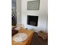 Cozy indoor fireplace with a decorative sign and shiplap. Woven table setting and hardwood floors at 101 E Hill Valley E Dr, Indianapolis, IN 46227