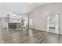 Open concept living room featuring hardwood floors, vaulted ceiling, and natural light at 10693 Newgate Ln, Indianapolis, IN 46231
