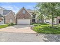 Traditional brick home with a two-car garage, driveway and manicured lawn in a suburban setting at 11244 Blackwalnut Pt, Indianapolis, IN 46236