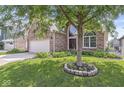 Beautiful brick home with well-kept lawn and mature trees, showcasing curb appeal at 11244 Blackwalnut Pt, Indianapolis, IN 46236