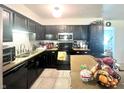 Functional kitchen featuring dark cabinetry and stainless steel appliances at 1129 Nantucket Dr, Cicero, IN 46034
