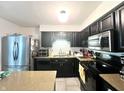 Functional kitchen featuring dark cabinetry and stainless steel appliances at 1129 Nantucket Dr, Cicero, IN 46034