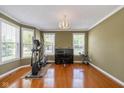 Bright and airy living room with large windows, exercise equipment, and piano at 12772 Tram Ln, Carmel, IN 46032