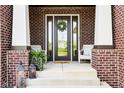 Cozy front porch with decorative lanterns, and comfortable seating beside the front door at 1521 Avondale Dr, Westfield, IN 46074