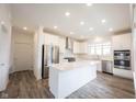 Modern kitchen featuring stainless steel appliances, white cabinets, gray flooring and a central island at 19800 Sutton Ter, Westfield, IN 46074