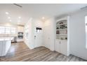 Bright, open-concept living space featuring hardwood floors, modern white trim and an entry door at 19800 Sutton Ter, Westfield, IN 46074