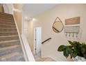 Inviting hallway featuring carpeted stairs, decorative accents, and natural light at 2125 Coretta Way, Indianapolis, IN 46202