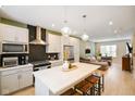 Stylish kitchen with a large island and seating, flowing into the living area at 2125 Coretta Way, Indianapolis, IN 46202