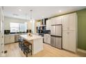 Modern kitchen features stainless steel appliances and a center island with seating at 2125 Coretta Way, Indianapolis, IN 46202