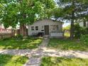 Charming single-story home with a cozy front yard and mature trees providing ample shade at 239 N 6Th Ave, Beech Grove, IN 46107